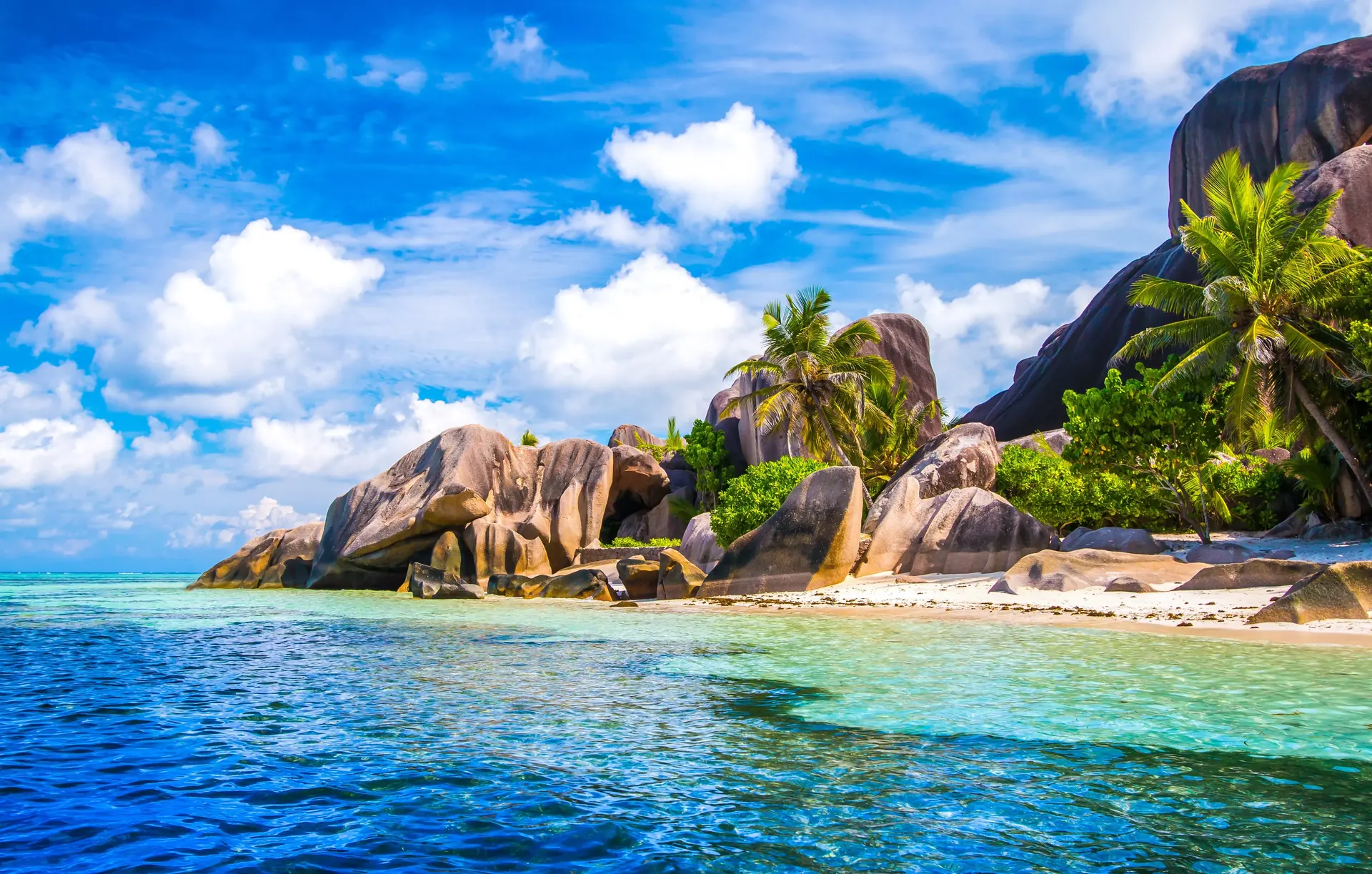 Granite boulders and a turquoise cove on a Seychelles beach