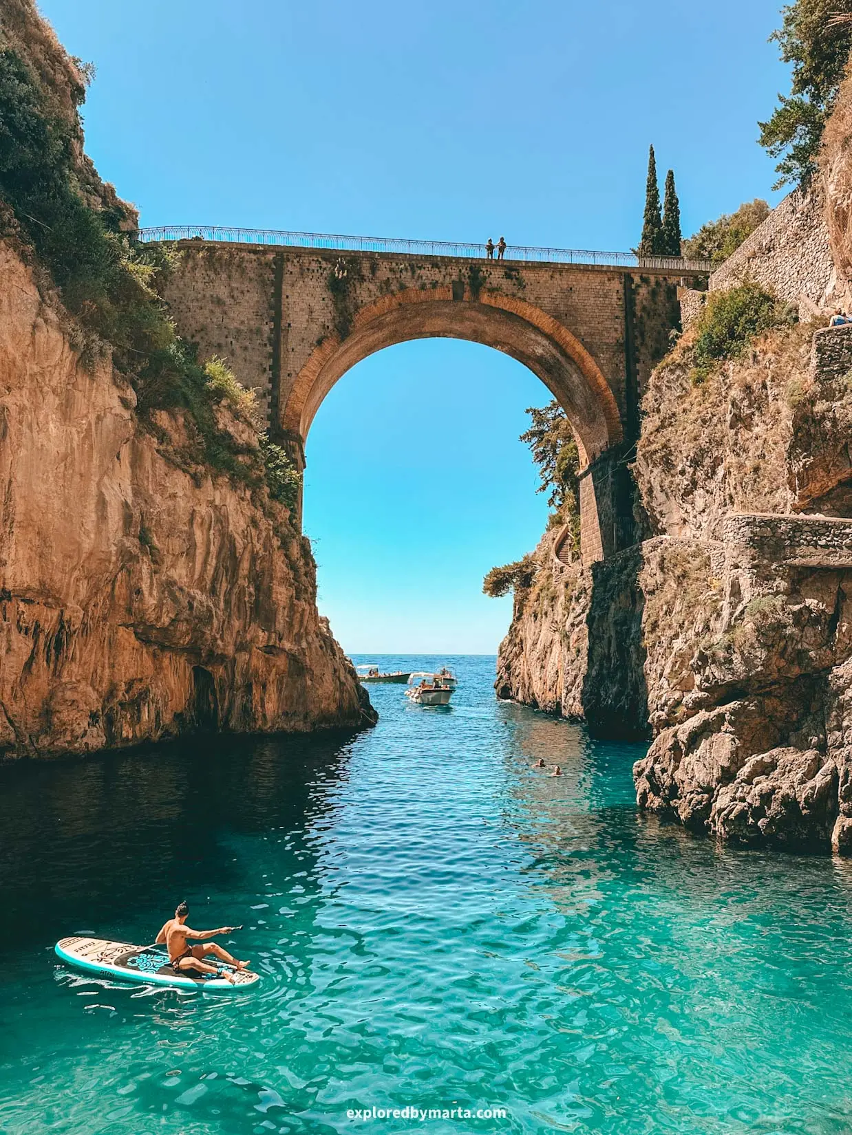 Rock arch over a turquoise inlet on Italy's Amalfi Coast