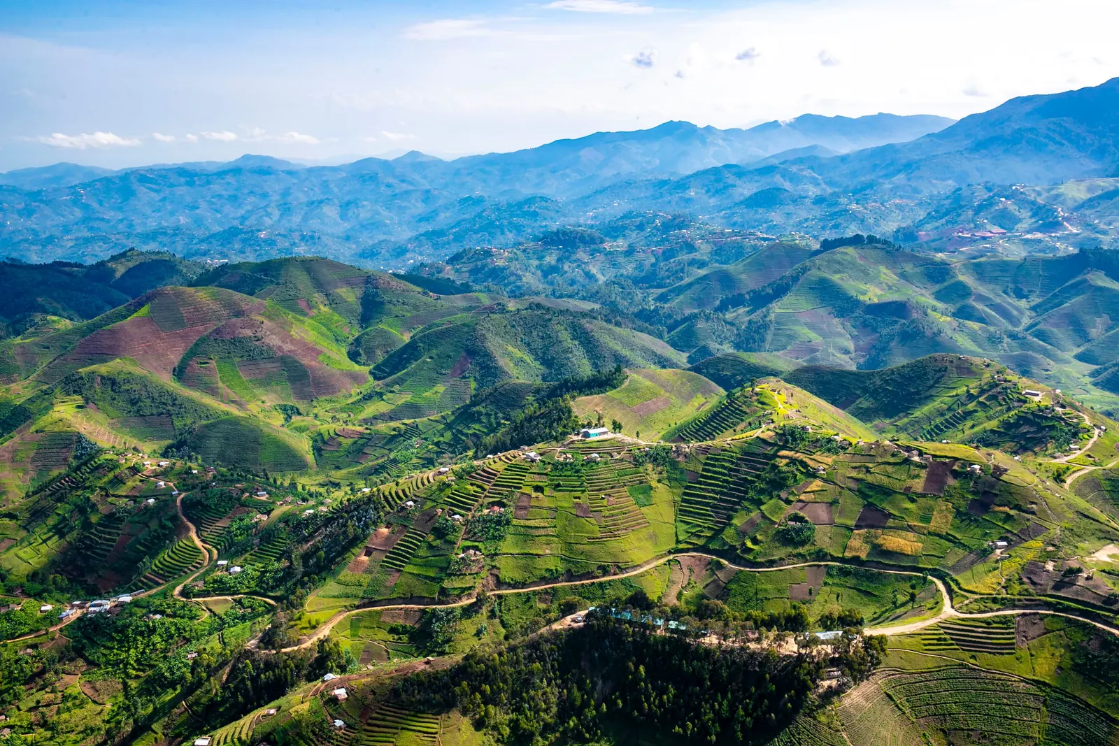 Green terraced hills and mountain ridges in Rwanda seen from above